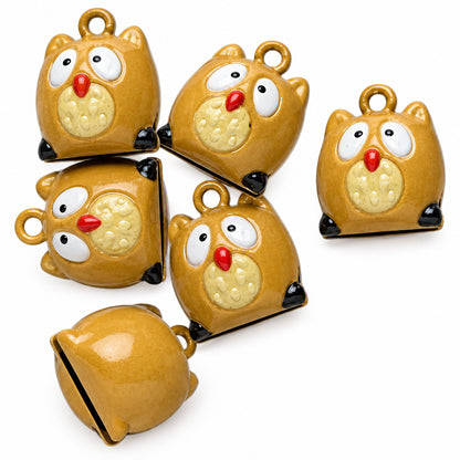 Five small owl-shaped bells in a glossy mustard yellow color, shown from different angles on a plain white background.