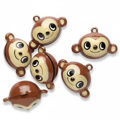 Six small monkey-shaped jingle bells in brown and cream, shown on a plain white background.