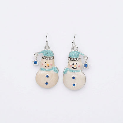 A pair of snowman-shaped dangle earrings with glittery light blue hats and scarves, silver hooks, and small blue rhinestone accents on a plain white background.