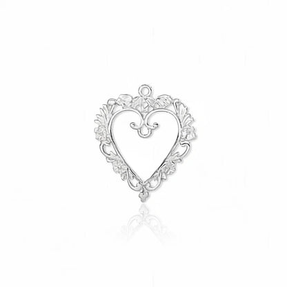 A silver heart-shaped ornamental jewelry charm with a decorative filigree border and a small top loop, shown on a plain white background.