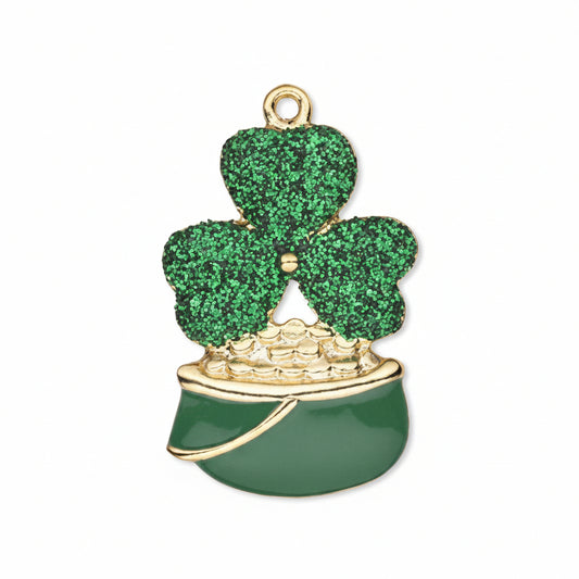 A St. Patrick's Day shamrock charm featuring a glittery green three-leaf clover on a gold-tone ring, sitting in a shiny dark green pot with gold trim and a small pile of gold coins.