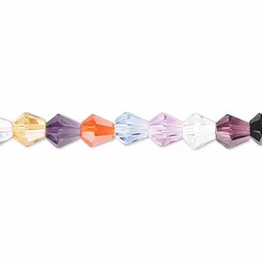 A close-up horizontal line of faceted crystal beads in assorted colors including yellow, purple, orange, light blue, lavender, white, and dark purple, set against a plain white background.