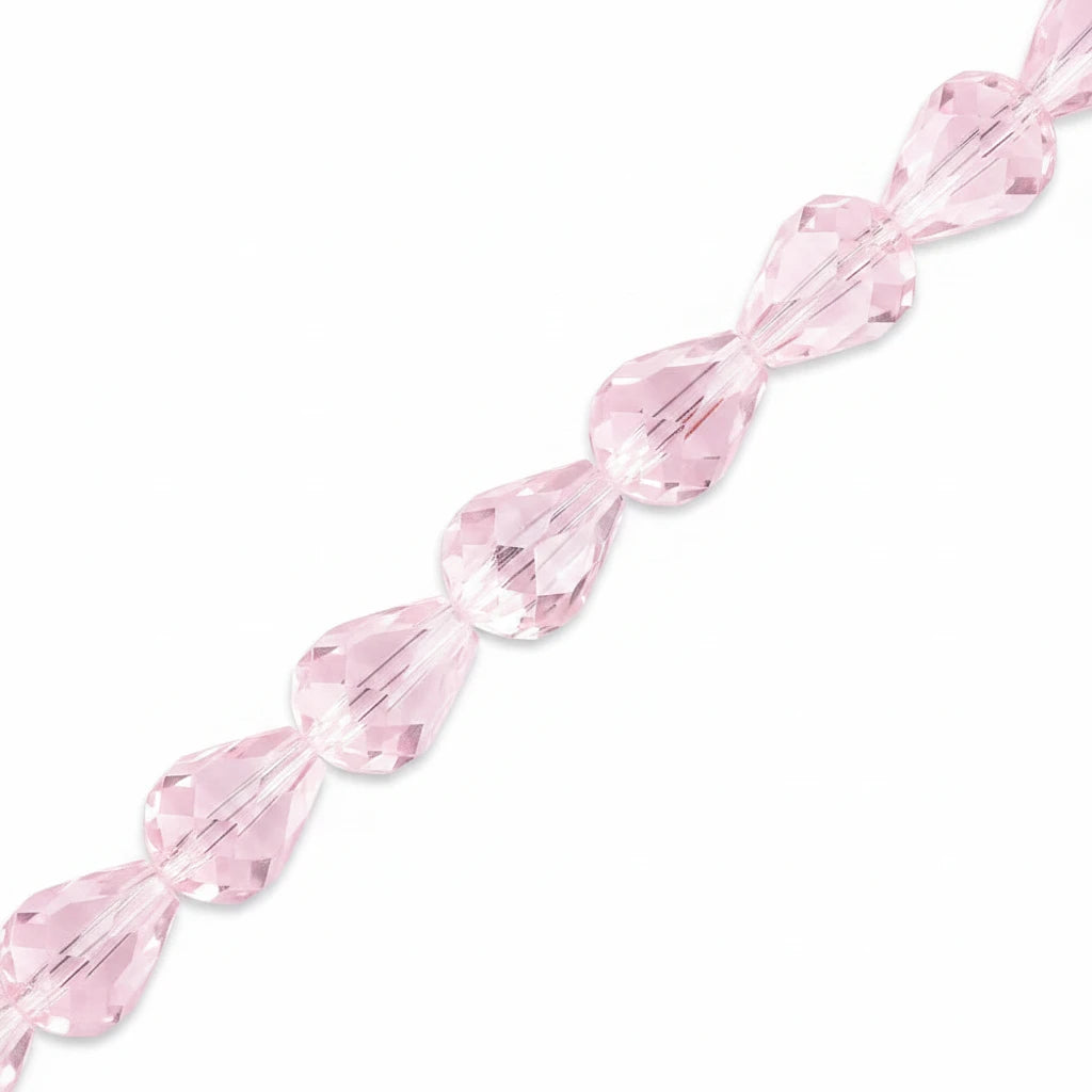 Faceted light pink teardrop-shaped beads strung in a single horizontal line on a plain white background.