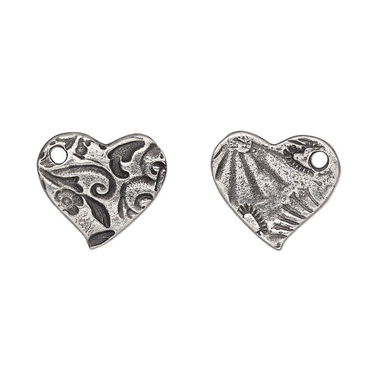 Two silver heart-shaped charms with textured, antiqued finishes and small hanging loops, displayed side by side on a plain white background.