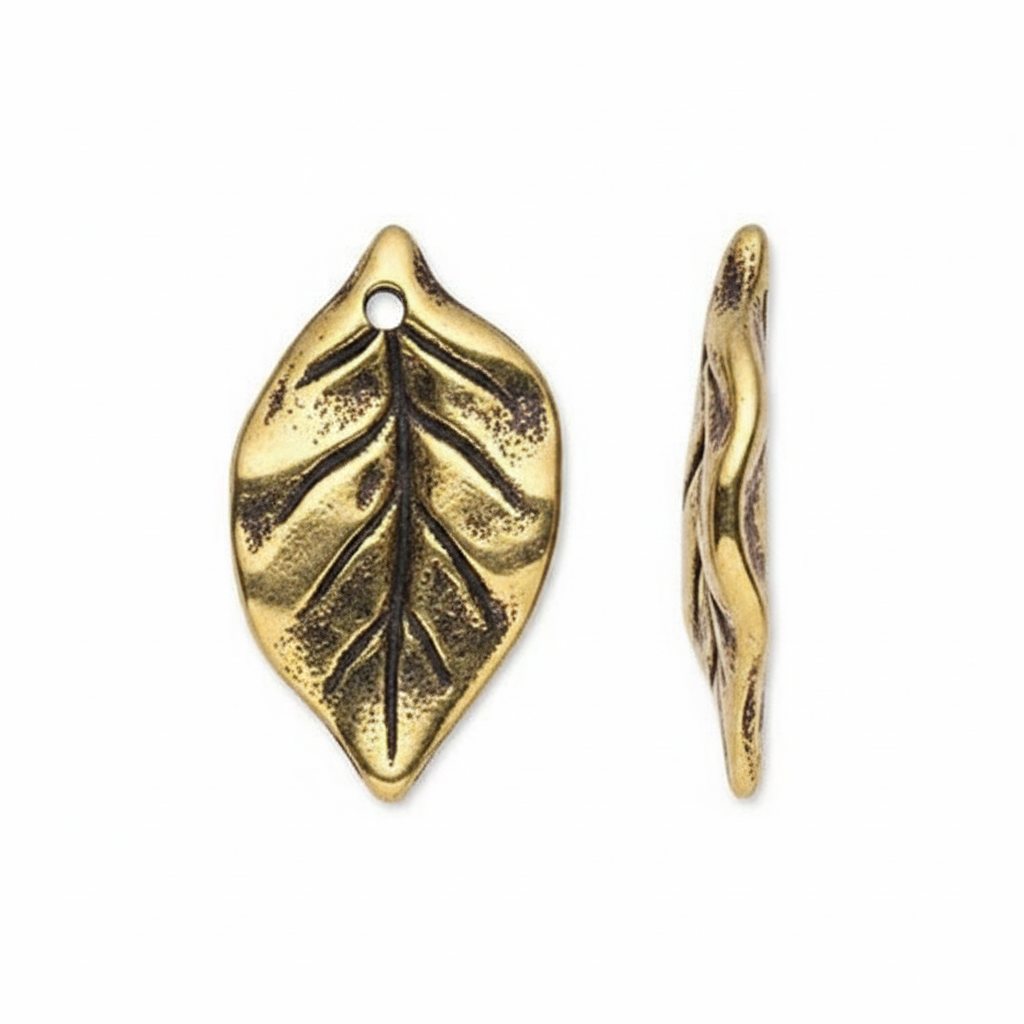 Two gold-toned metal leaf charms with textured vein details and a hanging hole, shown on a plain white background.