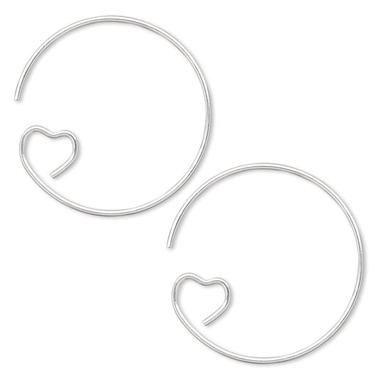 Silver hoop earrings with heart-shaped ends on a white background