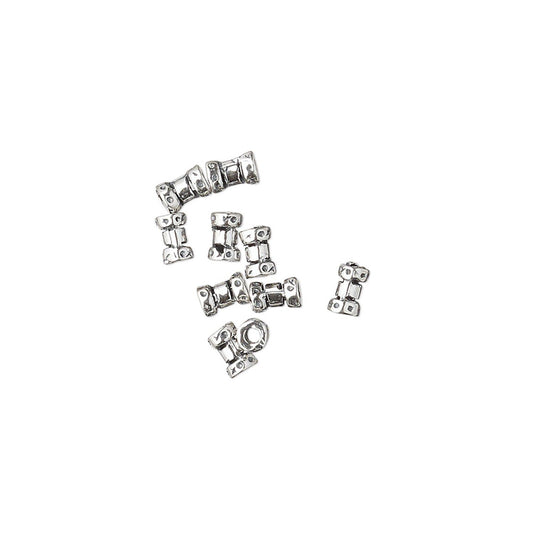 A group of small silver metal bead charms shaped like stylized figures, arranged on a plain white background.