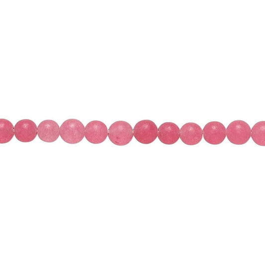 A single strand of round, polished pink beads laid horizontally against a plain white background.