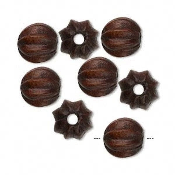 Set of brown wooden beads and flower-shaped items on a white background