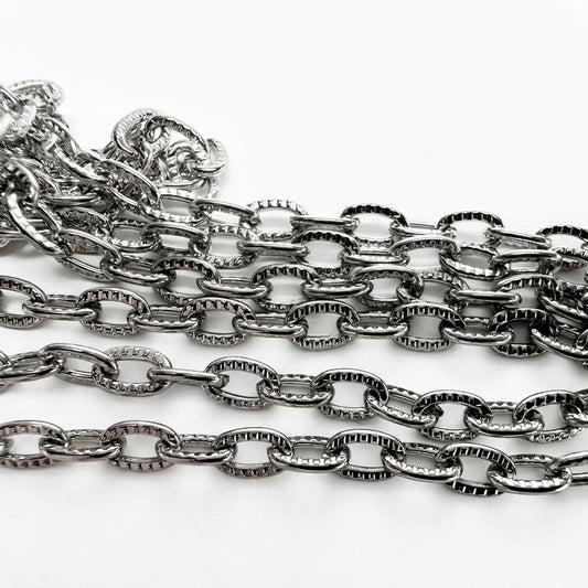 A coiled silver-toned metal chain with textured links,