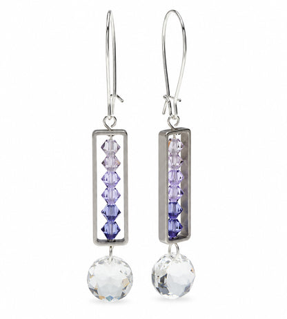 Silver-toned drop earrings with rectangular bezel settings holding four faceted lavender beads, finished with a large clear crystal pendant and fishhook wires. A small '*Sample Only' note appears below.