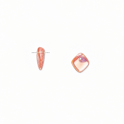 Two small PINK GLASS on a plain white background, one elongated teardrop-shaped stone and one rounded square-shaped stone, both in a pale pinkish-orange translucent color with a milky white center.