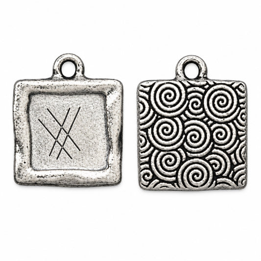 Two silver square charms with rounded corners on a white background. The left charm shows a simple engraved symbol, while the right charm features an intricate pattern of interlocking spirals.