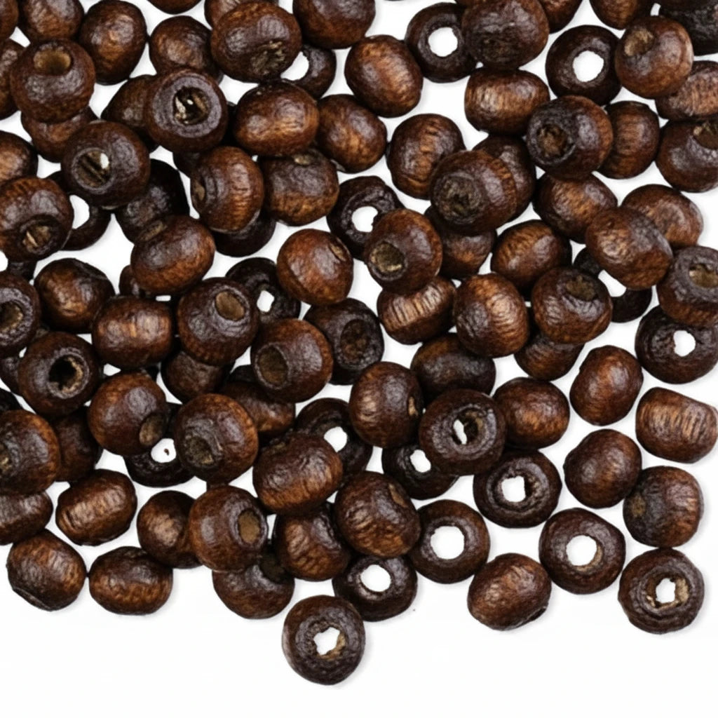 Dark brown wooden seed beads with hollow centers, scattered on a plain white background.