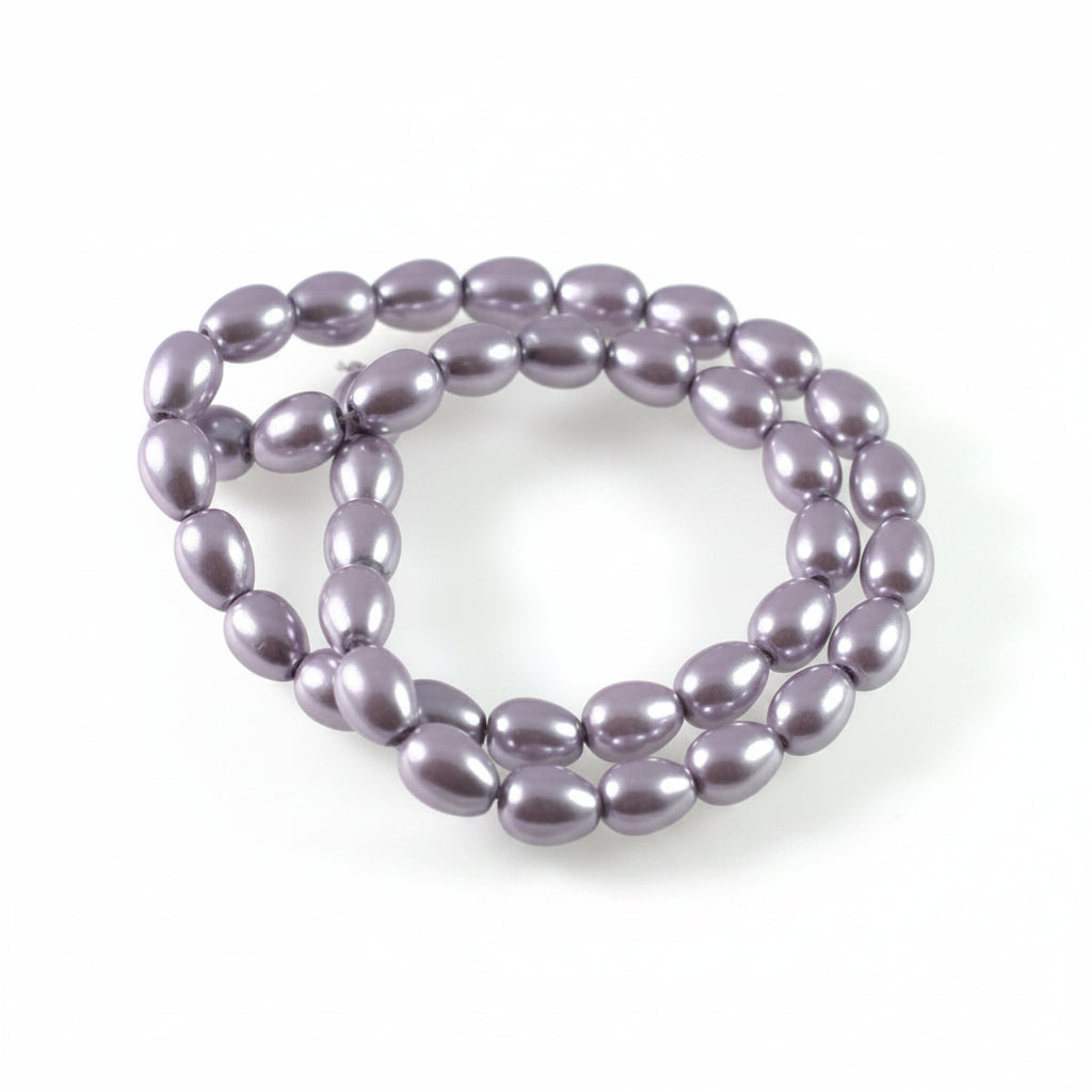 A strand of glossy, oval-shaped lavender beads arranged in a loop on a plain white background.