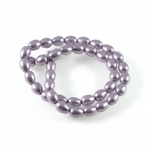 A strand of glossy, oval-shaped lavender beads arranged in a loop on a plain white background.