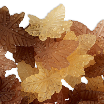 A pile of translucent leaf-shaped beads in various shades of amber, tan, and dark brown, arranged on a white background.