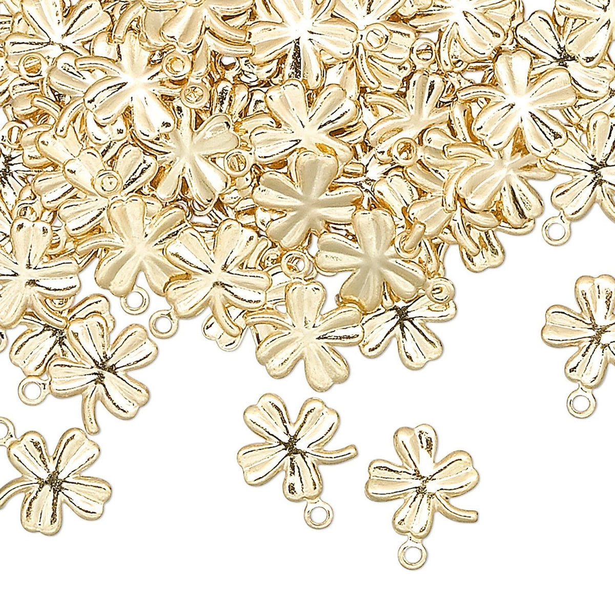 A pile of small metallic flower-shaped charms with loops at the top, scattered across a plain white background.