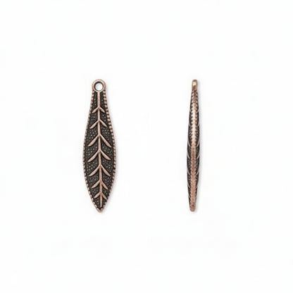 Two antique bronze leaf-shaped jewelry charms with detailed vein patterns, shown on a plain white background.