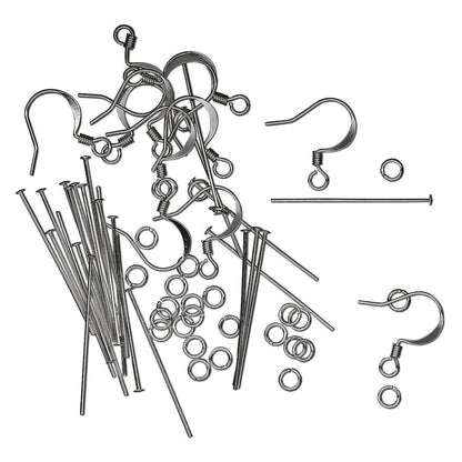 A set of silver metal jewelry findings, including various ear wires, jump rings, and straight pins, arranged on a plain white background.