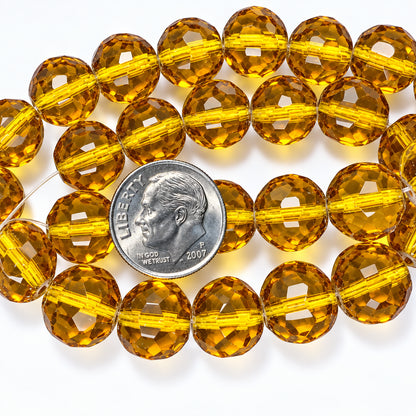 Faceted amber glass beads on a clear string, shown with a US dime for scale on a white background.