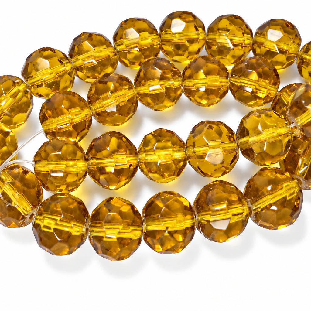 Faceted amber glass beads on a white background.