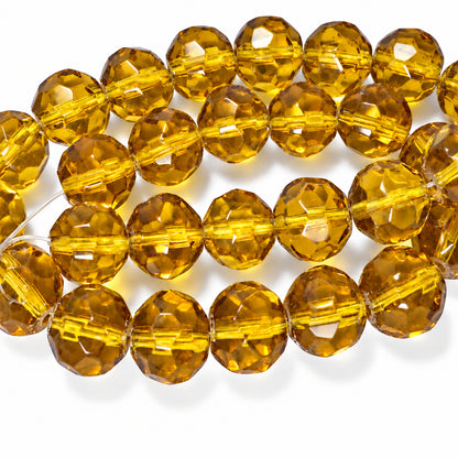 Faceted amber glass beads on a white background.