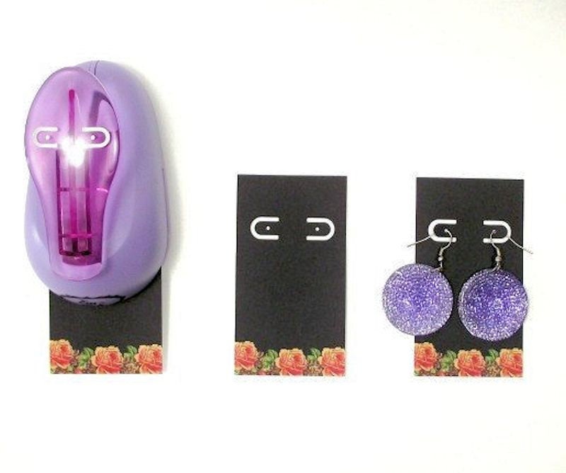 Purple light bulb and earrings on floral-patterned cards with a white background