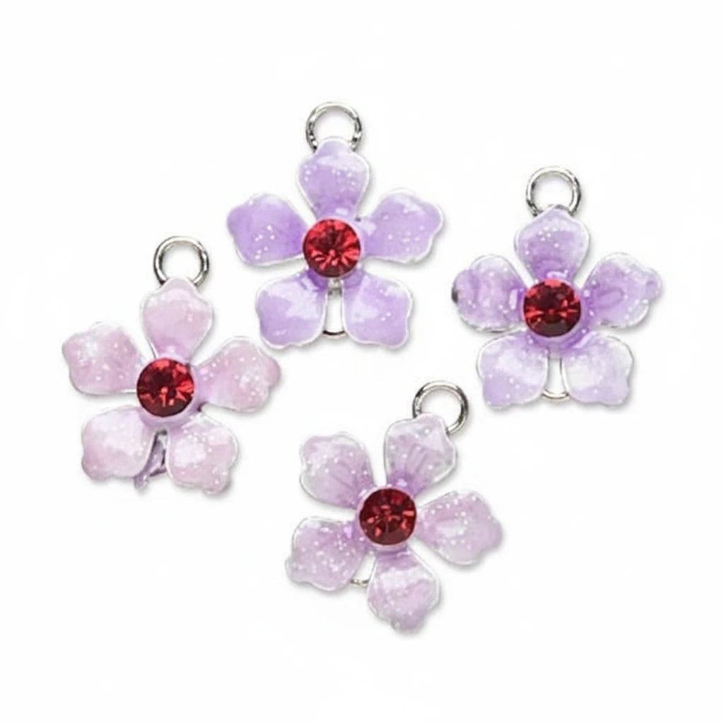 Four glittery flower-shaped jewelry charms in light purple and pale pink, each with a red faceted crystal center and a silver metal loop at the top, arranged on a plain white background.