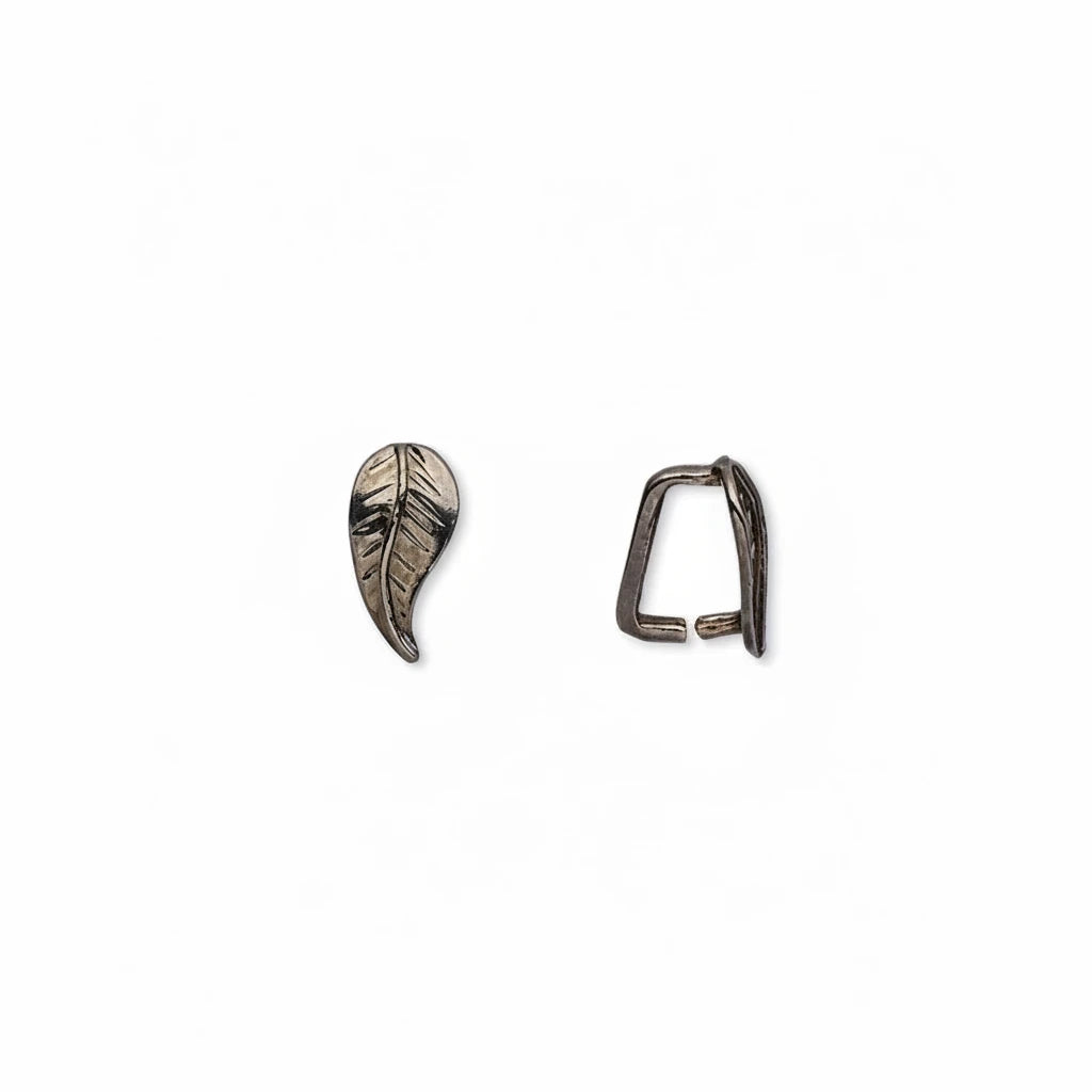 A pair of small metal jewelry findings on a plain white background: a leaf-shaped charm with engraved leaf veins and a matching open loop clasp.