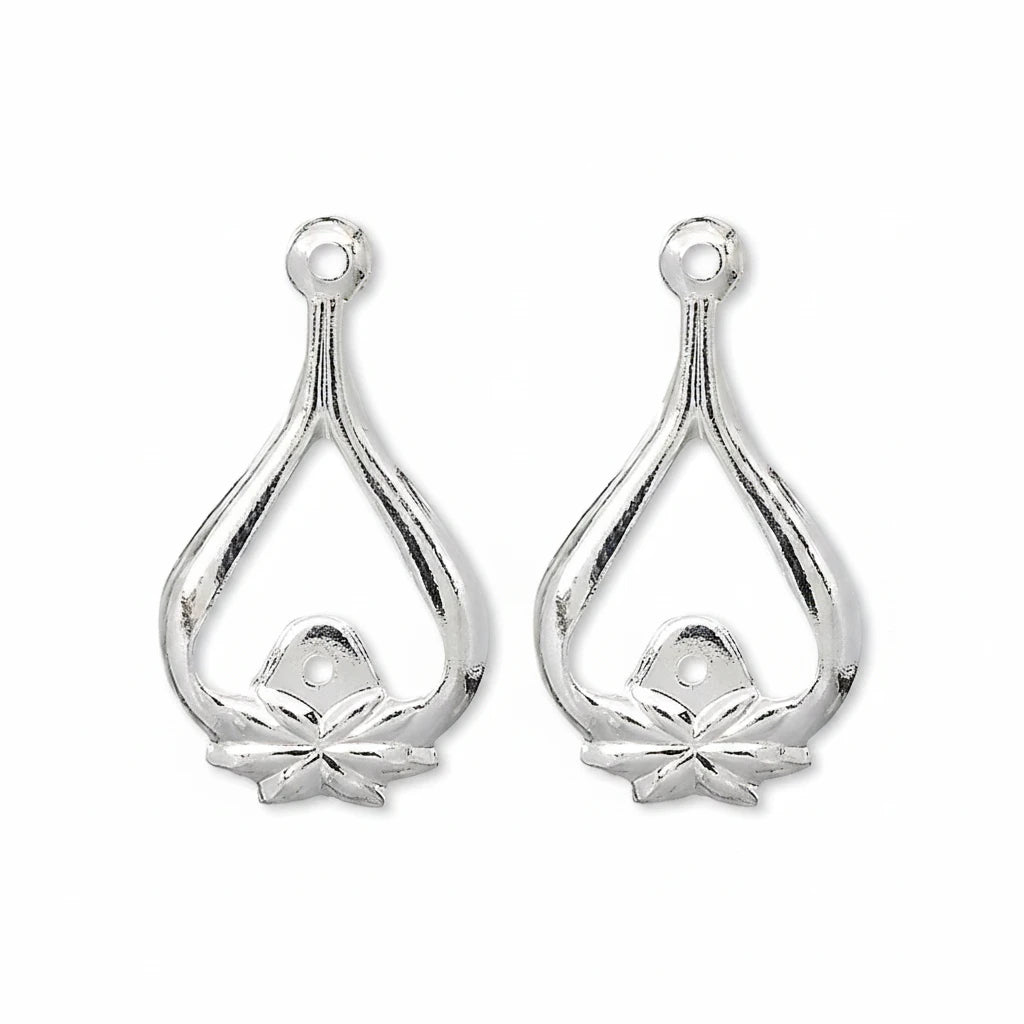 A pair of silver teardrop-shaped jewelry findings with a small flower detail at the bottom and a hole at the top for attachment.