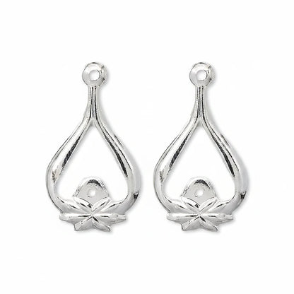 A pair of silver teardrop-shaped jewelry findings with a small flower detail at the bottom and a hole at the top for attachment.