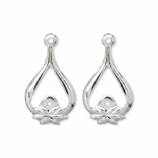 A pair of silver teardrop-shaped jewelry findings with a small flower detail at the bottom and a hole at the top for attachment.