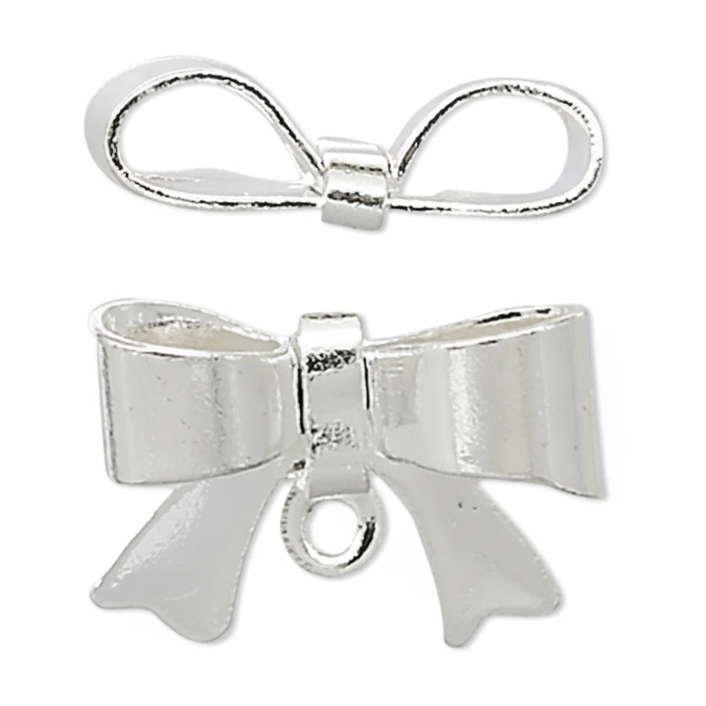 A pair of silver bow charms, one flat and one with a hanging loop, shown on a plain white background.