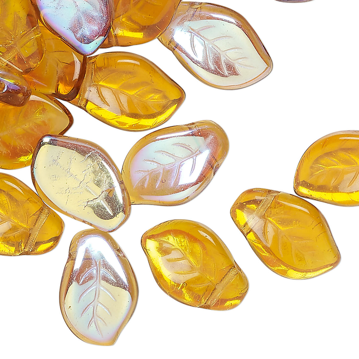 A cluster of translucent amber-yellow glass beads with a leaf vein pattern, some showing a pearlescent iridescent finish, scattered on a plain white background.