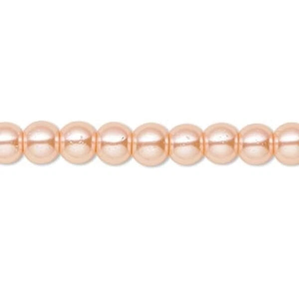 A strand of round, lustrous peach-pink pearls aligned horizontally against a plain white background.