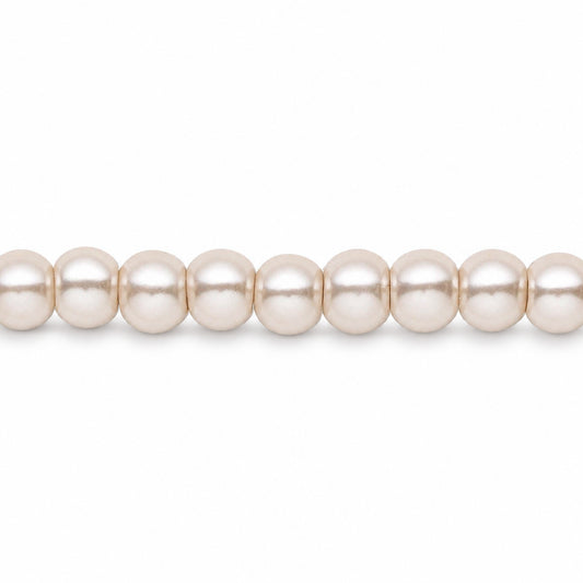 A close-up of a strand of round, lustrous pearl-like beads in a warm off-white or cream color, shown against a plain white background.