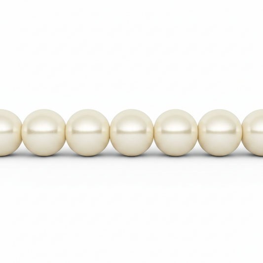 A close-up of a strand of creamy white freshwater pearls aligned horizontally against a solid white background.