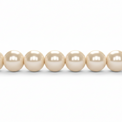 A close-up of a strand of round, lustrous pearl-like beads in a warm cream or ivory tone against a plain white background.
