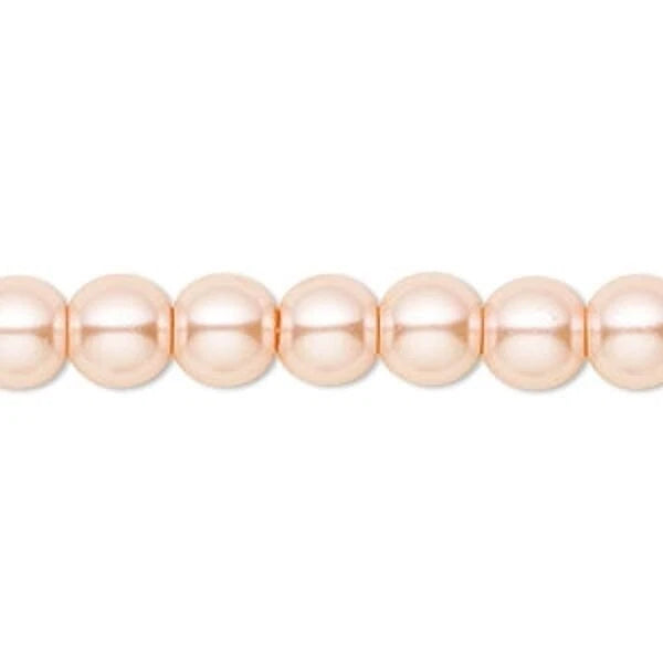 A close-up of a strand of round, glossy peach-pink beads on a plain white background.