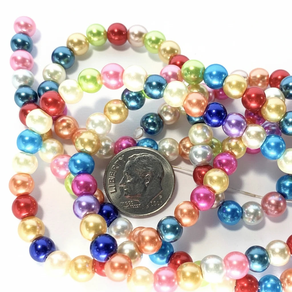 Multicolor round pearl beads in various colors, coiled together with a US quarter coin for scale on a white background.