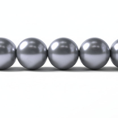 A close-up of five metallic silver beads aligned horizontally on a plain white background.