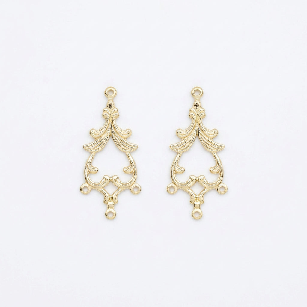 A pair of gold-plated ornate metal jewelry findings with a baroque-style scrollwork design and hanging loops, shown on a plain white background.