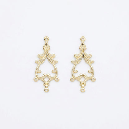 A pair of gold-plated ornate metal jewelry findings with a baroque-style scrollwork design and hanging loops, shown on a plain white background.
