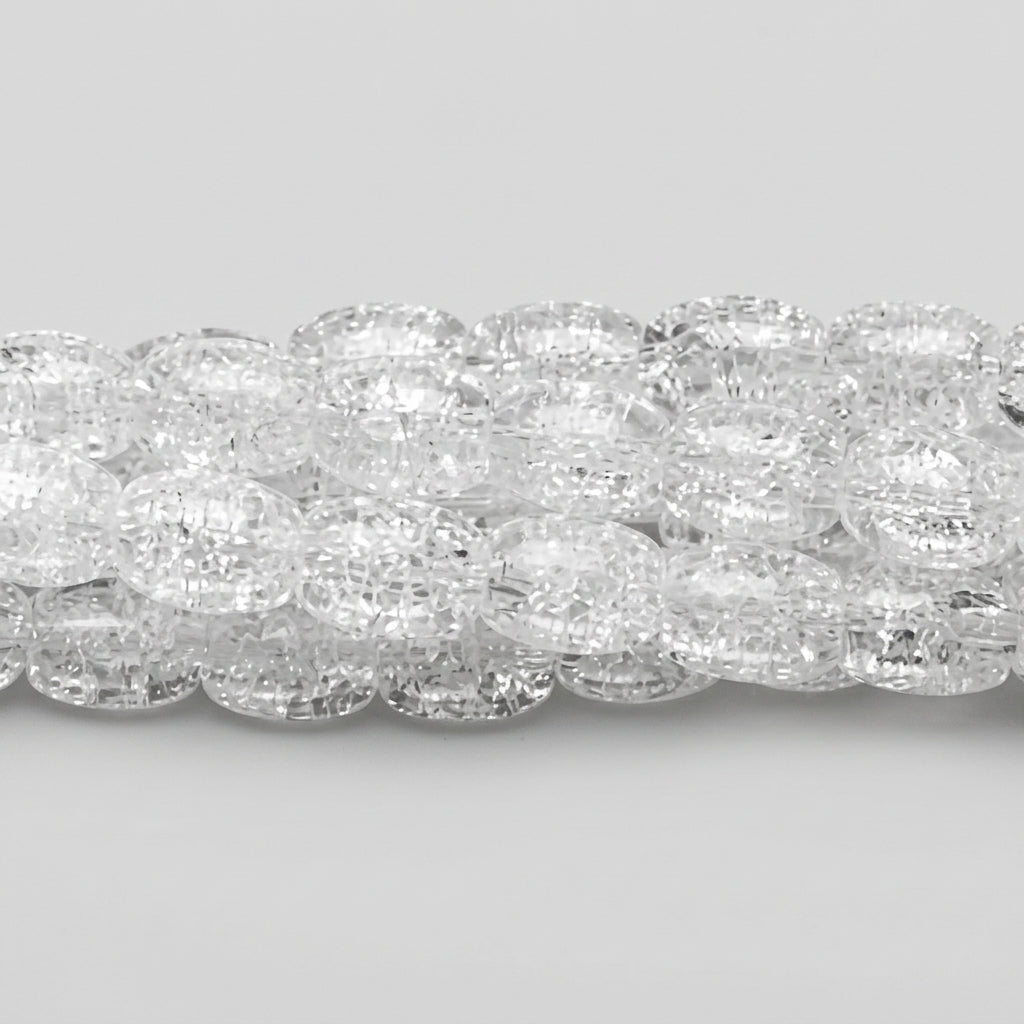 A close-up of a strand of clear, faceted oval beads on a dark gray background.
