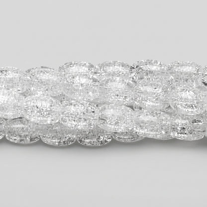 A close-up of a strand of clear, faceted oval beads on a dark gray background.