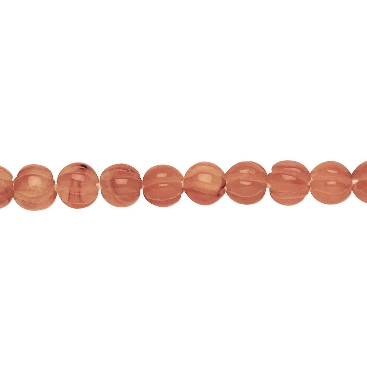 A strand of polished, oval-shaped peach-orange beads with a smooth, glossy finish, displayed horizontally against a solid white background.