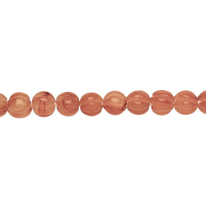 A strand of polished, oval-shaped peach-orange beads with a smooth, glossy finish, displayed horizontally against a solid white background.