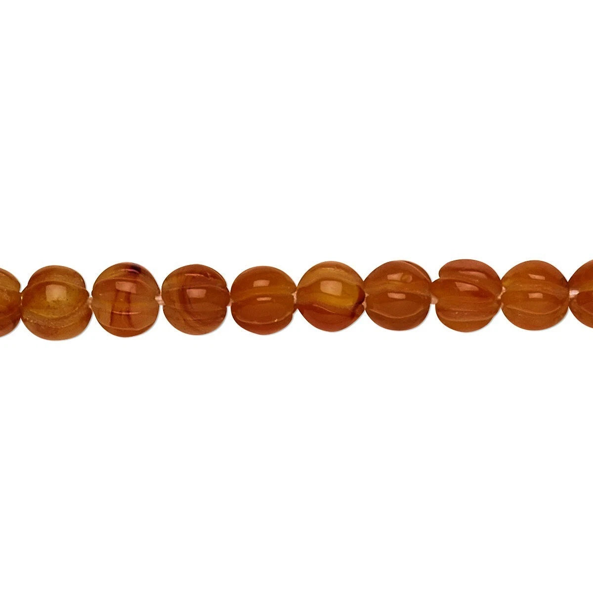 A close-up horizontal line of polished round amber beads in warm orange-brown tones on a plain white background.
