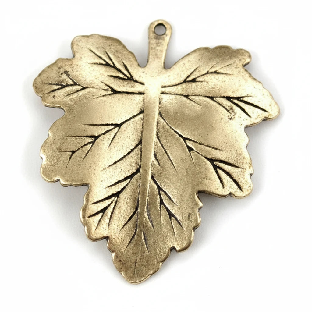 A single metallic leaf-shaped pendant or charm with a small loop at the top, shown on a plain white background.
